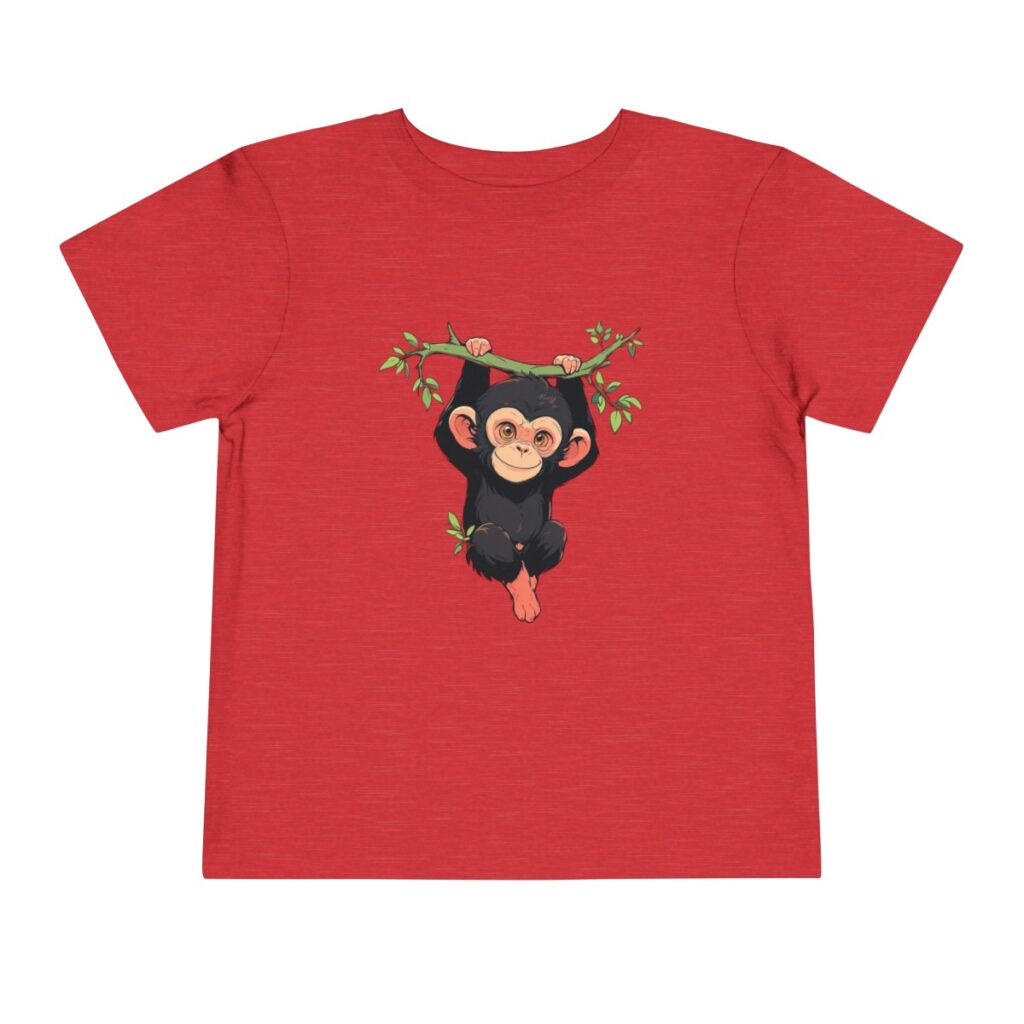 A cute baby chimpanzee design tshirt for toddlers hanging from a tree branch